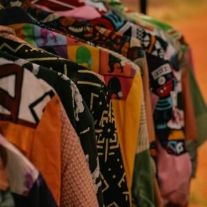 Vibrant vintage shirts displayed on hangers, showcasing unique patterns in an outdoor setting.